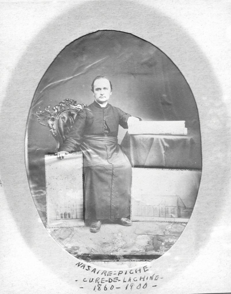 Father Nazaire Piché with the church building plans 