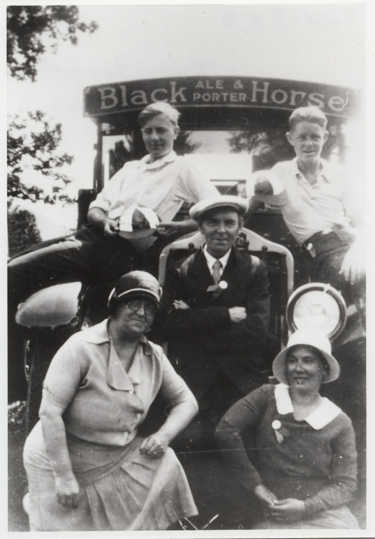 Group portrait with a Black Horse truck at a Dawes picnic  