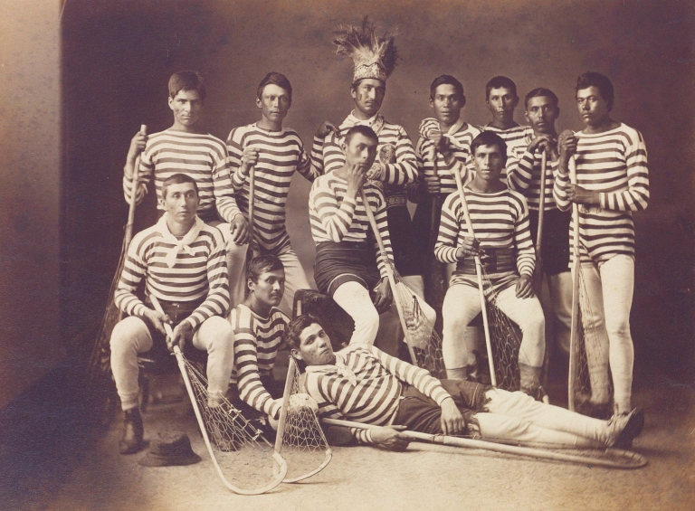 Kahnawake lacrosse team, 1876. Big John (centre) wearing a Mohawk headdress