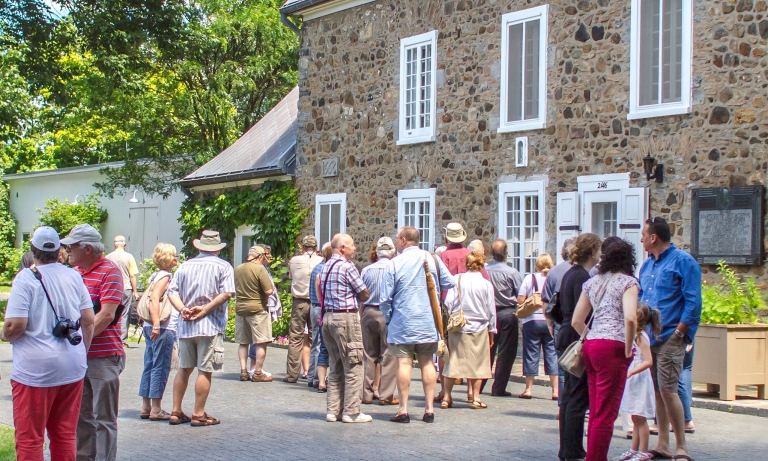 Visitors in front of Maison Saint-Gabriel